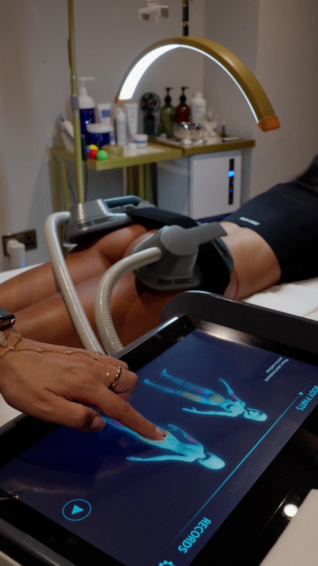 A Waldor Clinic practitioner reviewing the body scan on the EMS and RF system before a treatment